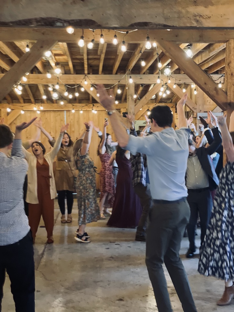 Rustic Alaska ceremony space with guests and string lights
